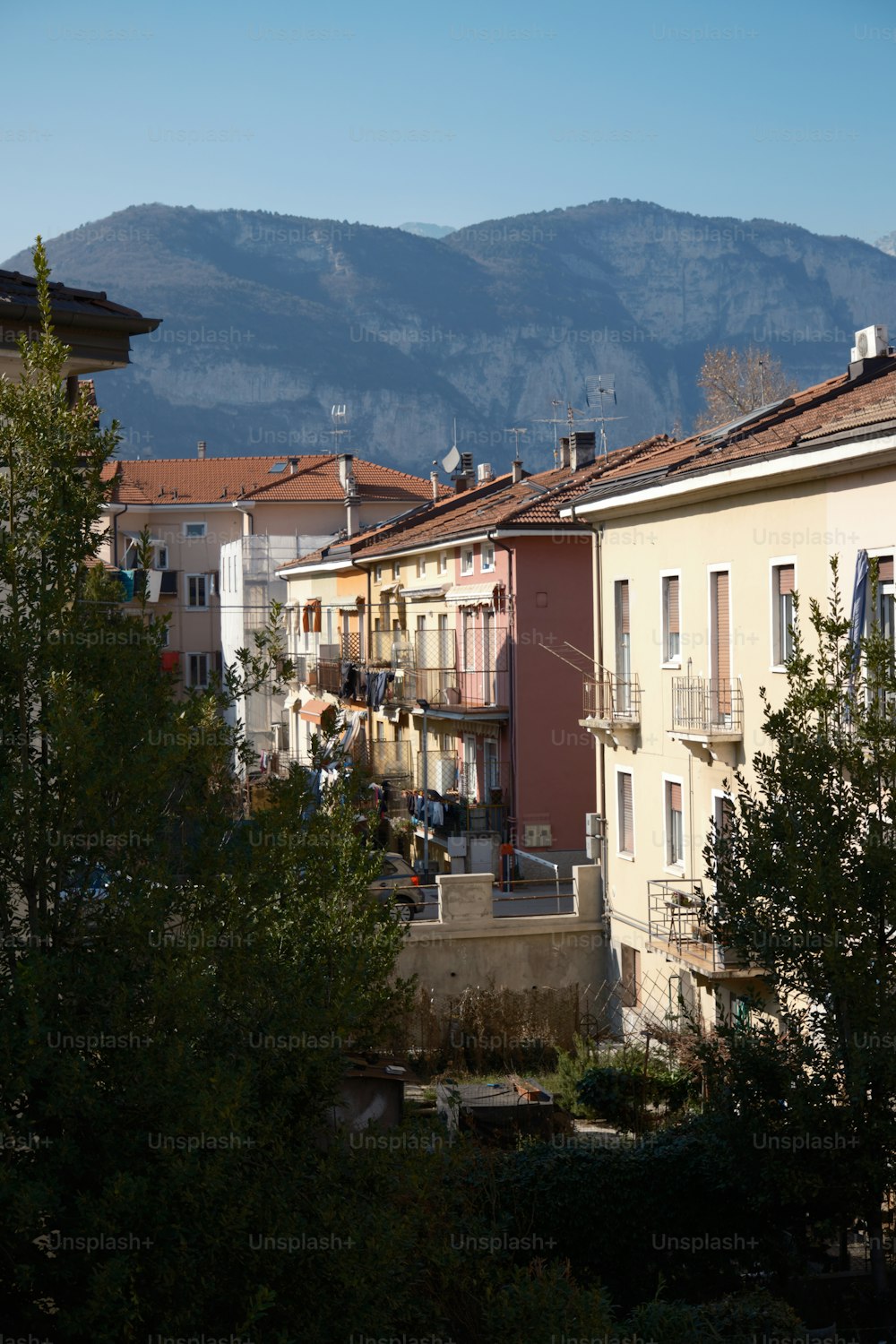 a row of buildings with a mountain in the background