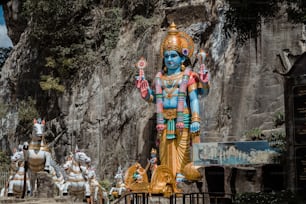 a statue of a hindu god surrounded by other statues