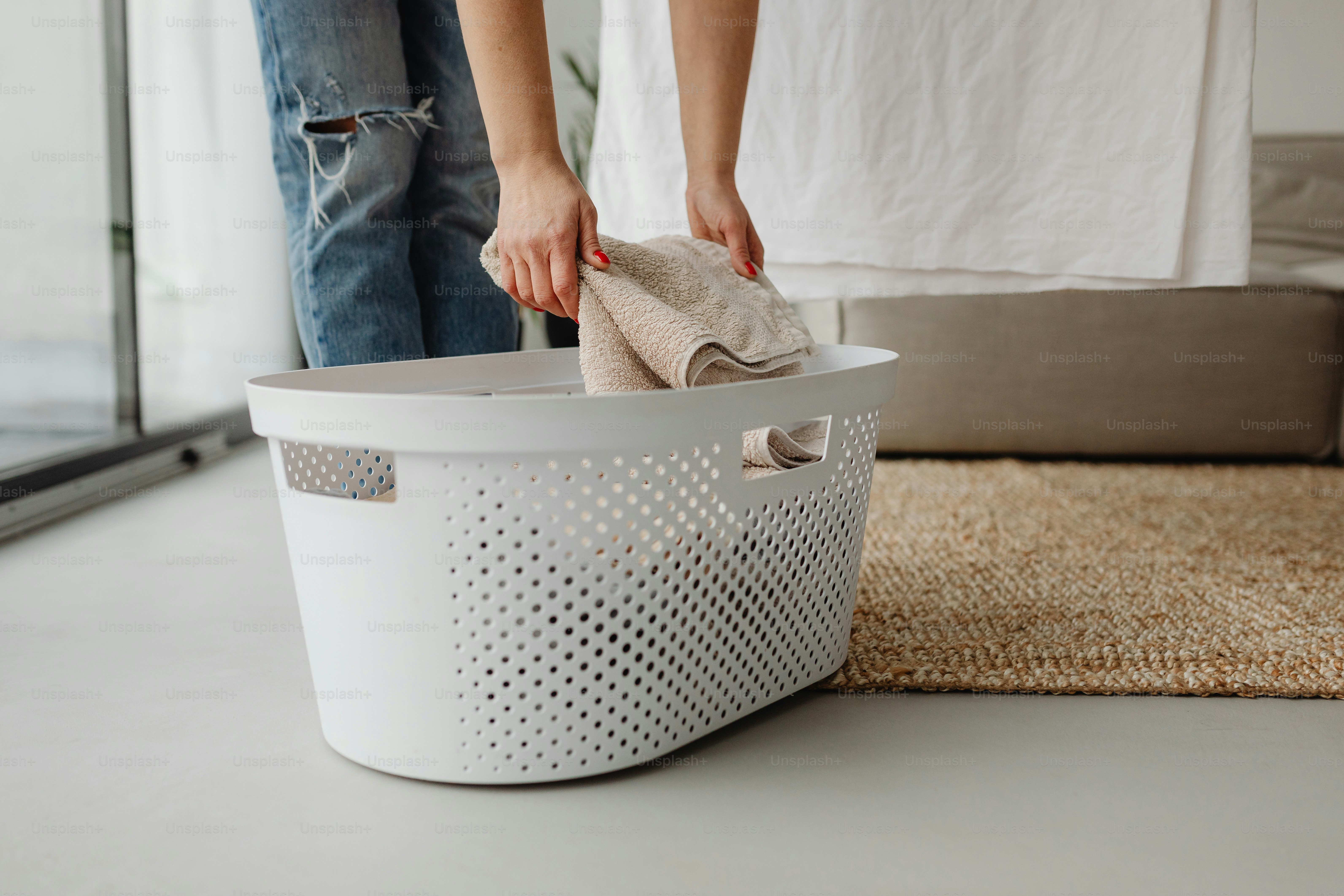 a person standing next to a laundry basket
