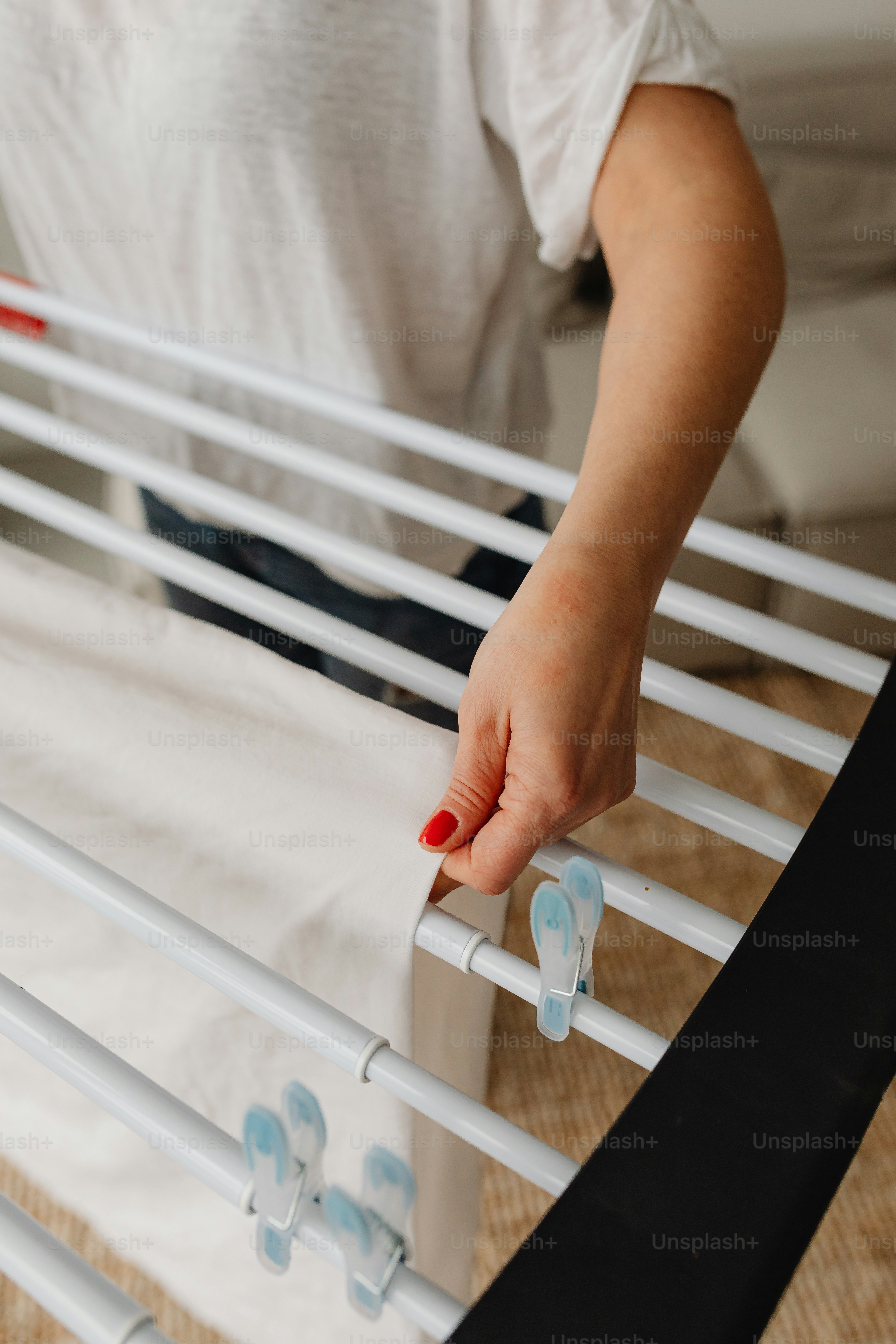 a person is putting something on a bed frame