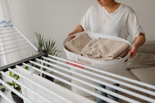 a woman is holding a basket full of towels