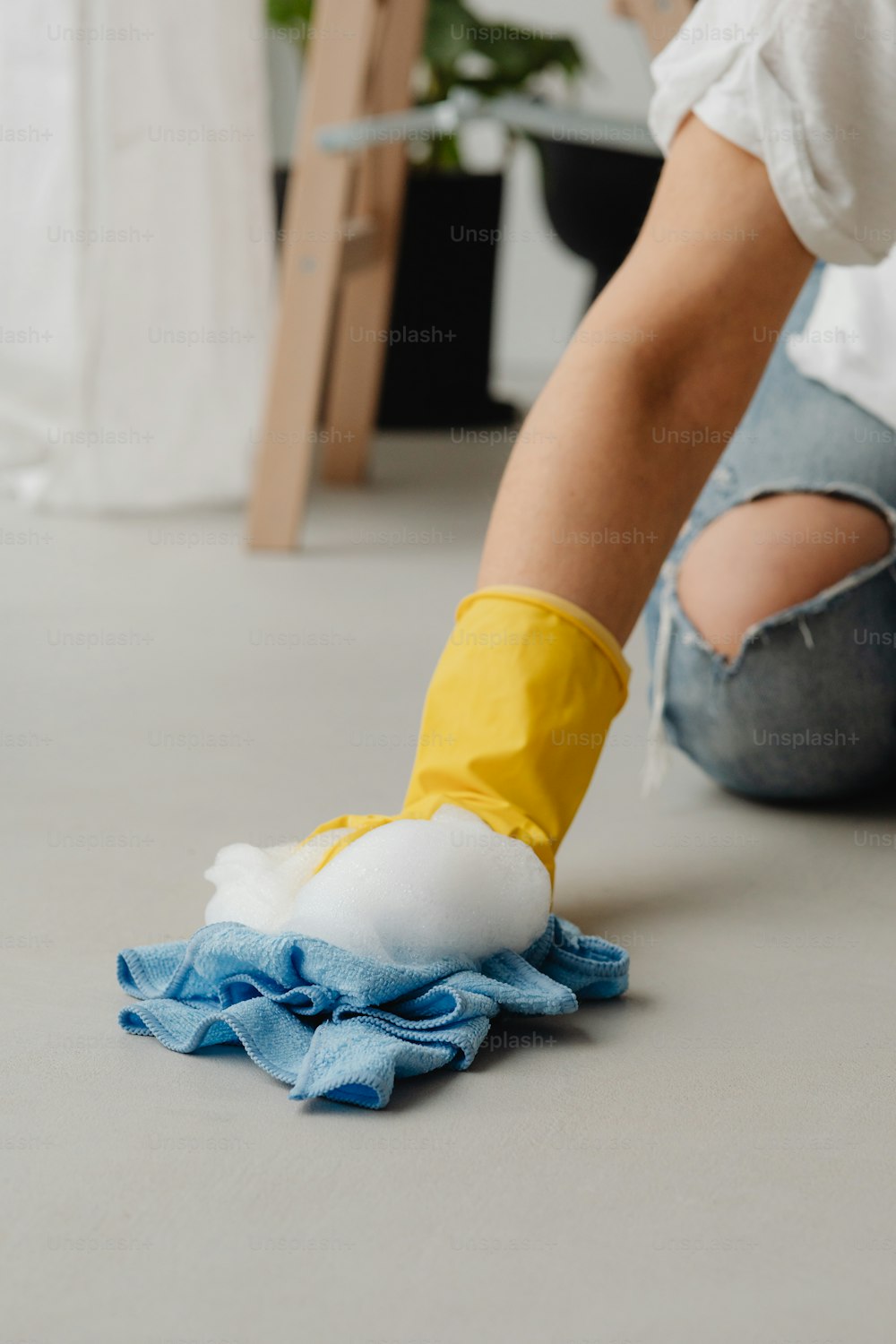 a person cleaning a floor with a rag