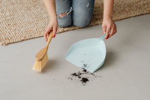 a woman scooping dirt out of a bowl with a wooden spatula