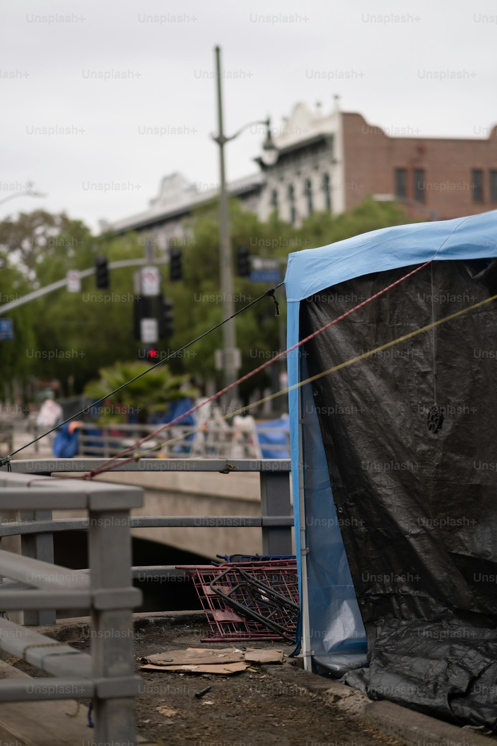 a black tarp covering a blue tent