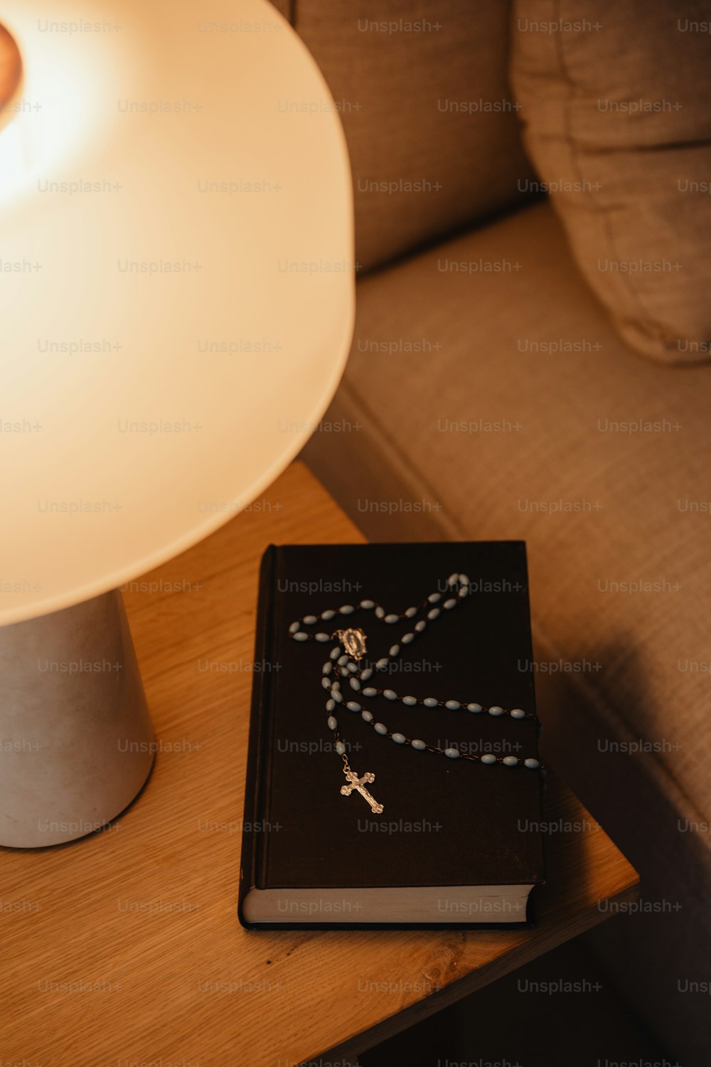um livro sentado em uma mesa ao lado de uma lâmpada