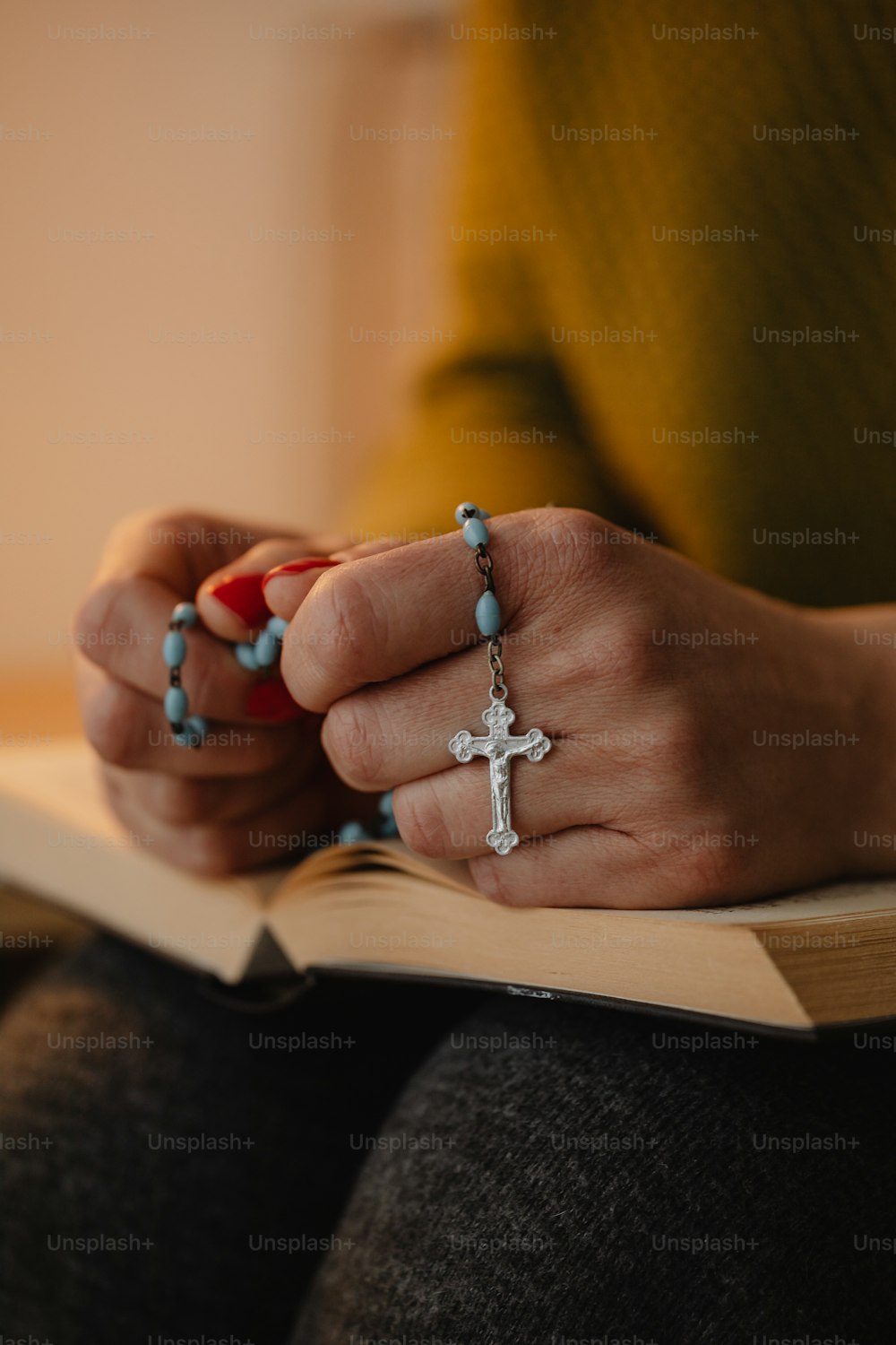 a woman holding a book with a cross on it