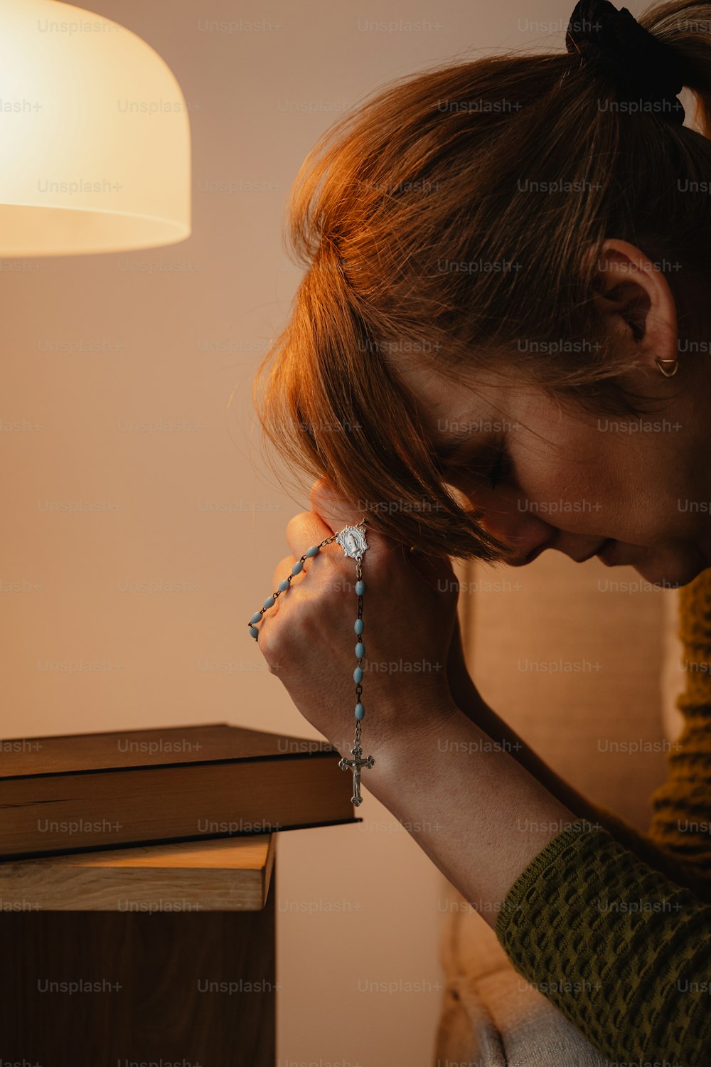 a woman holding a rosary in her hands