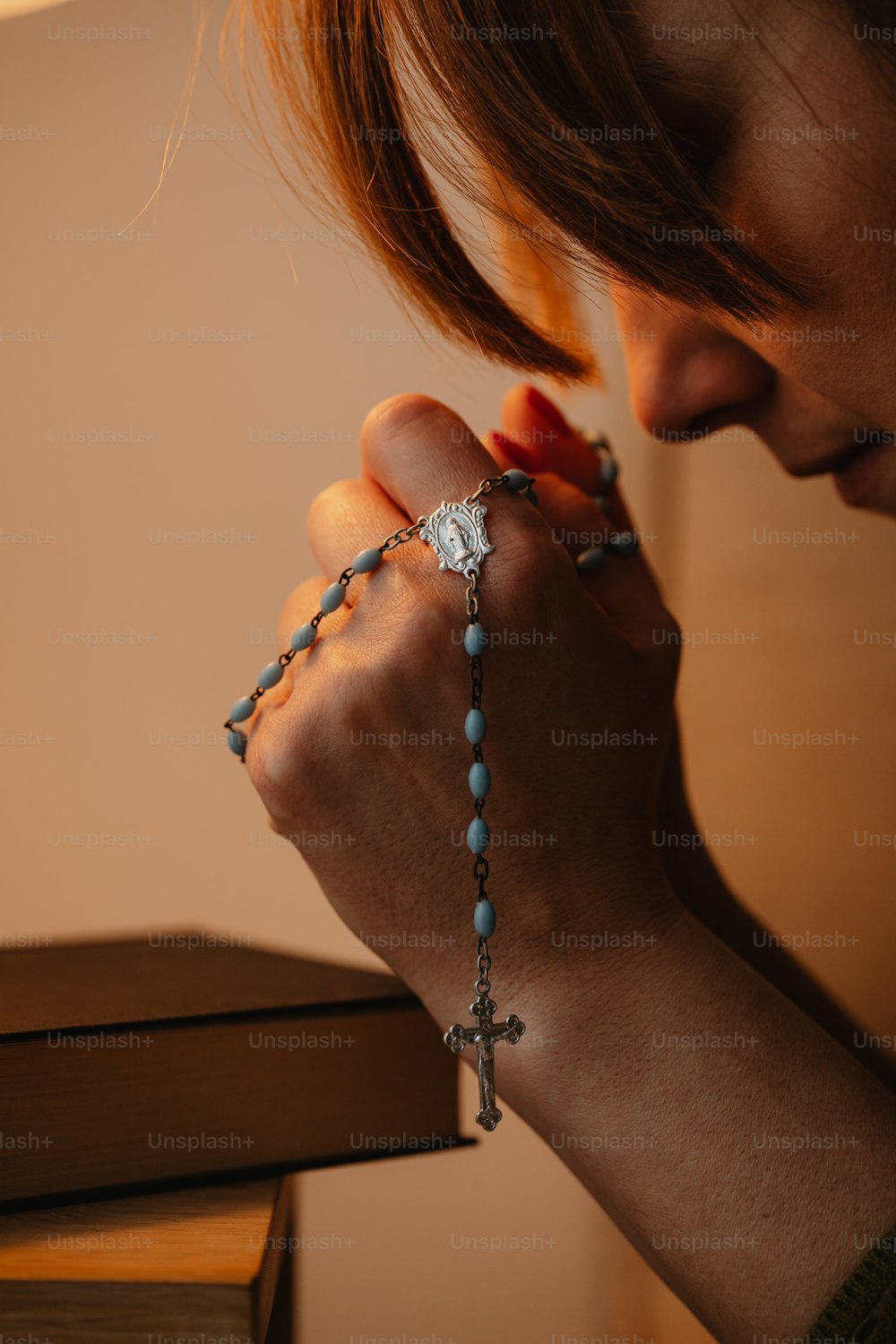 a woman wearing a rosary and a cross bracelet