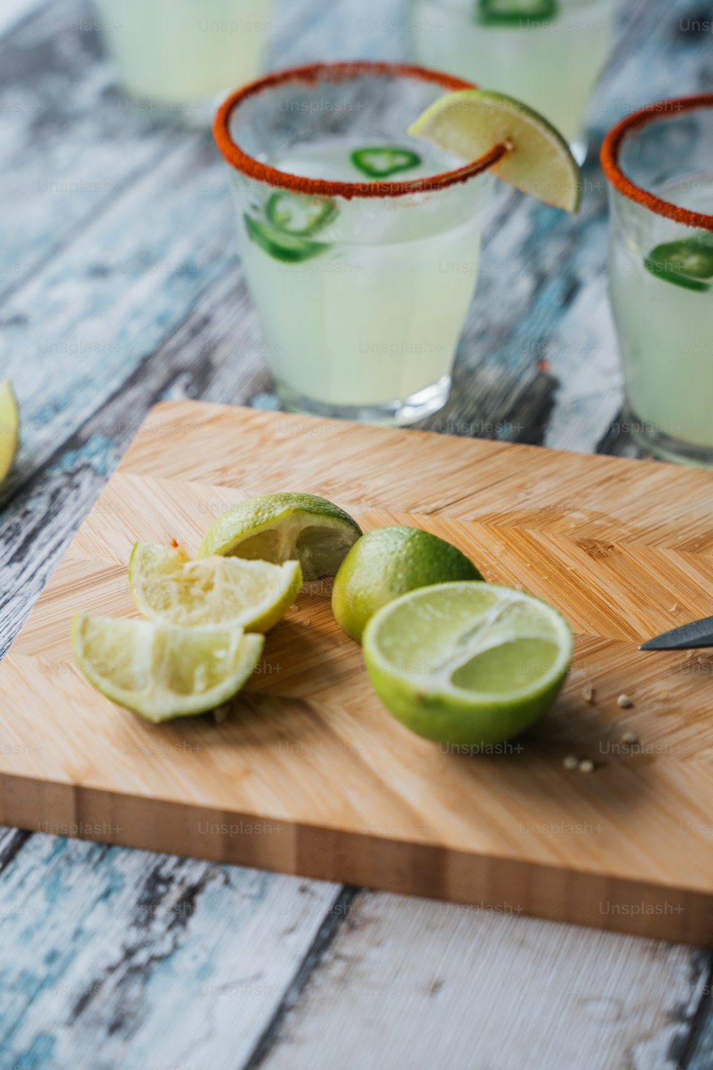 a cutting board with limes and limeade on it