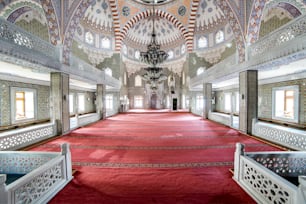 a large room with a red carpet and a chandelier