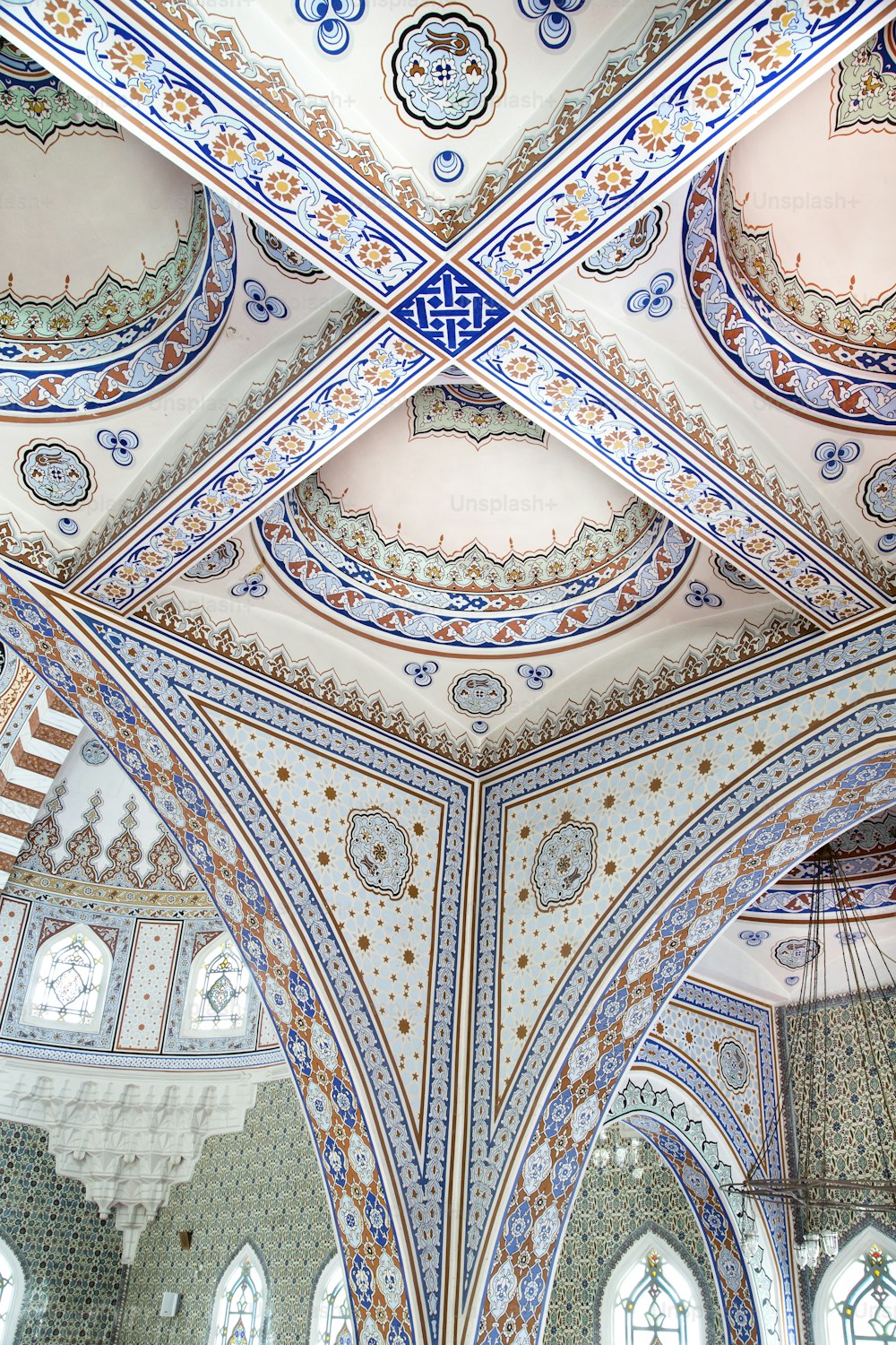 the ceiling of a building with intricate designs