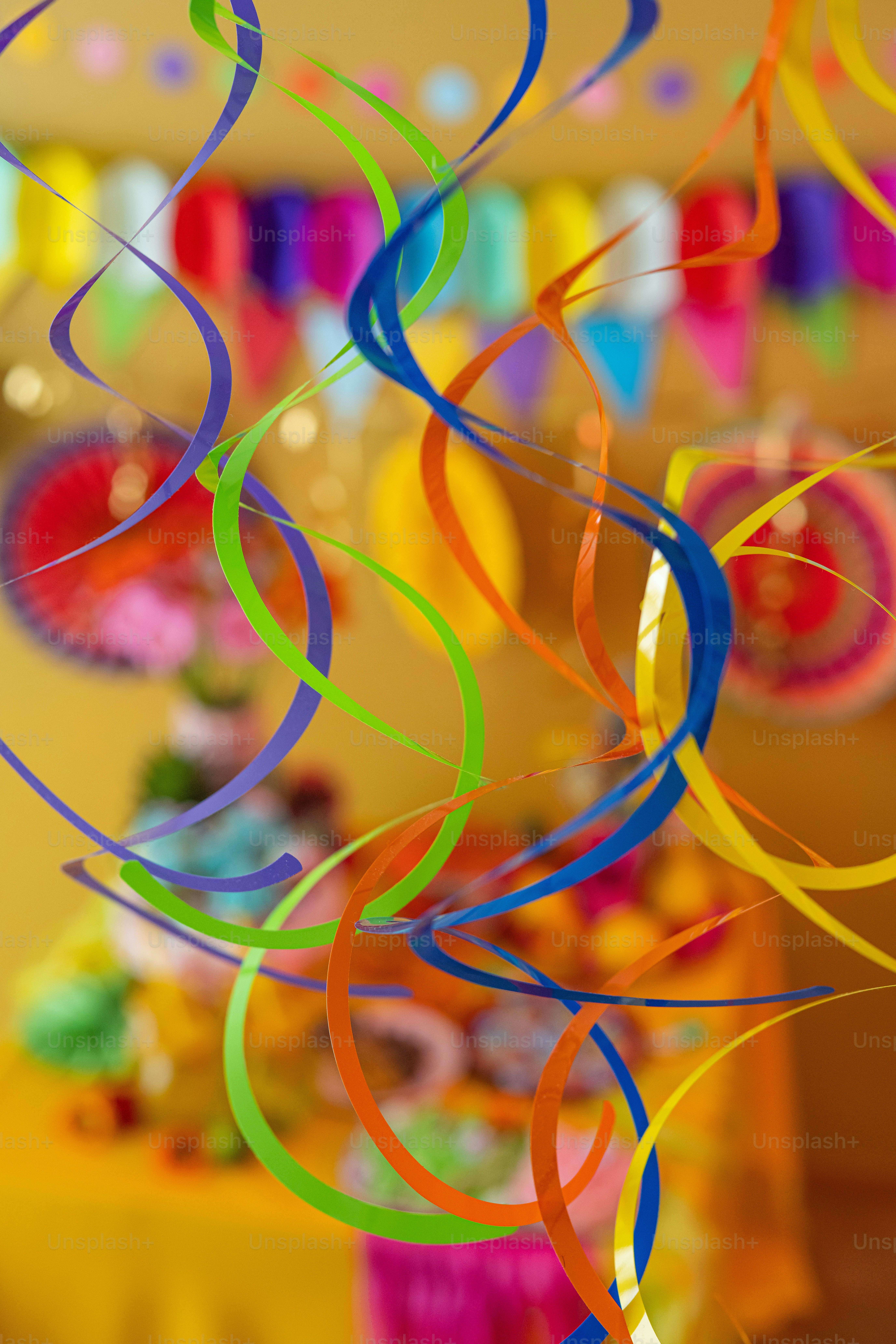 A bunch of colorful streamers hanging from a ceiling photo