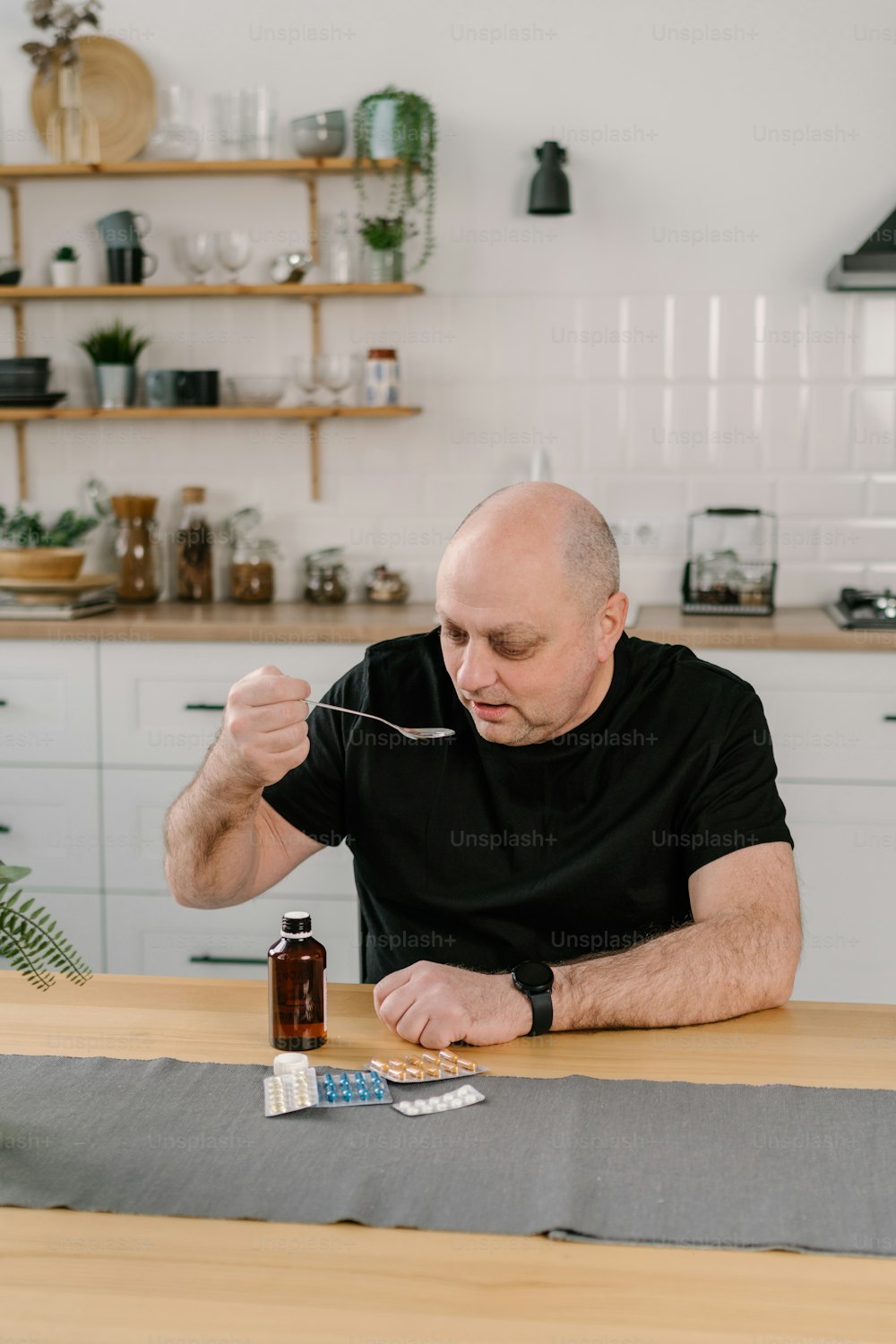 a man sitting at a table with a spoon in his hand