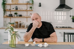 a man sitting at a table with a napkin in front of him