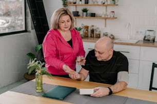 a man and a woman sitting at a kitchen table