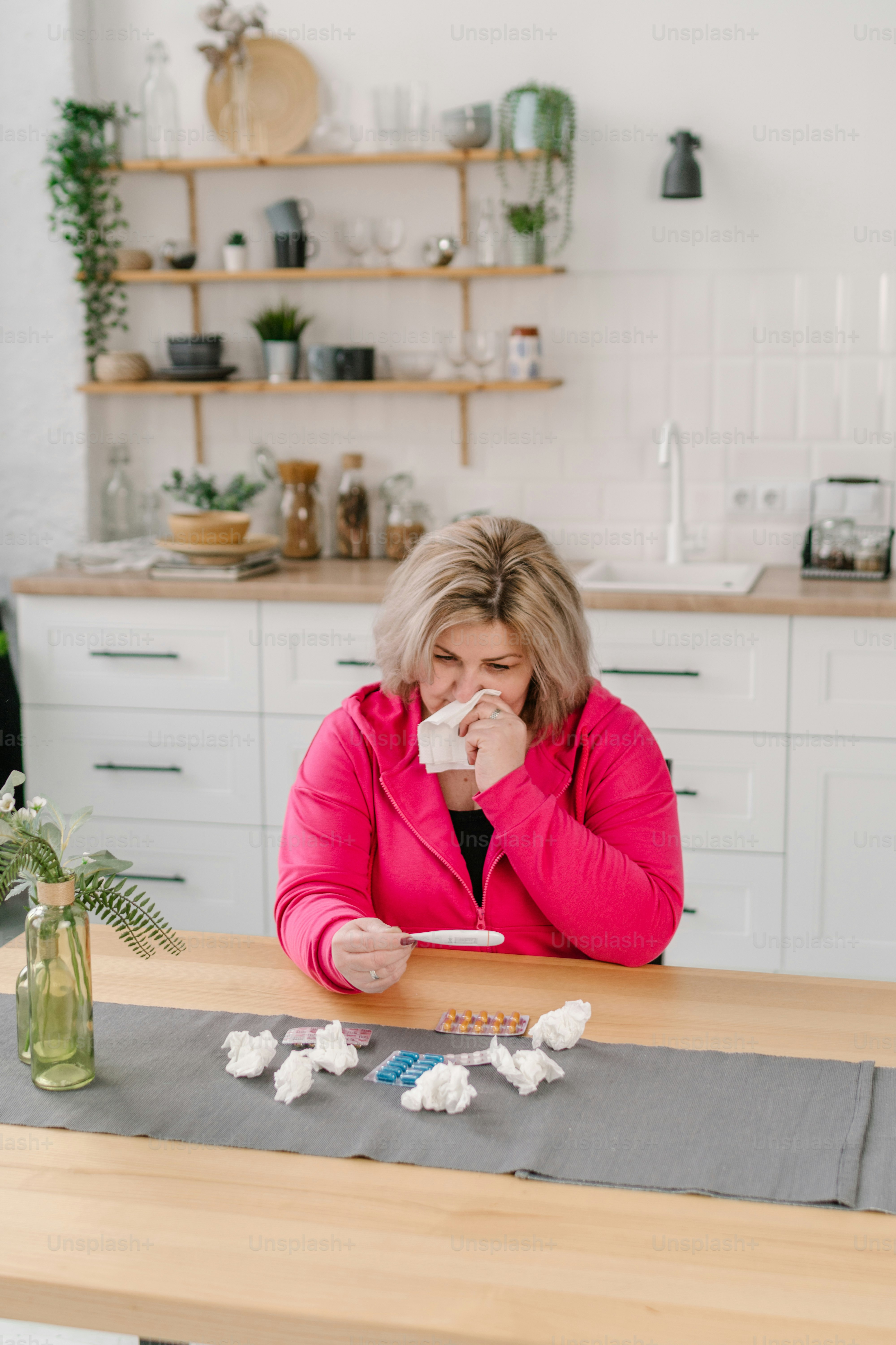 a woman sitting at a table in a kitchen