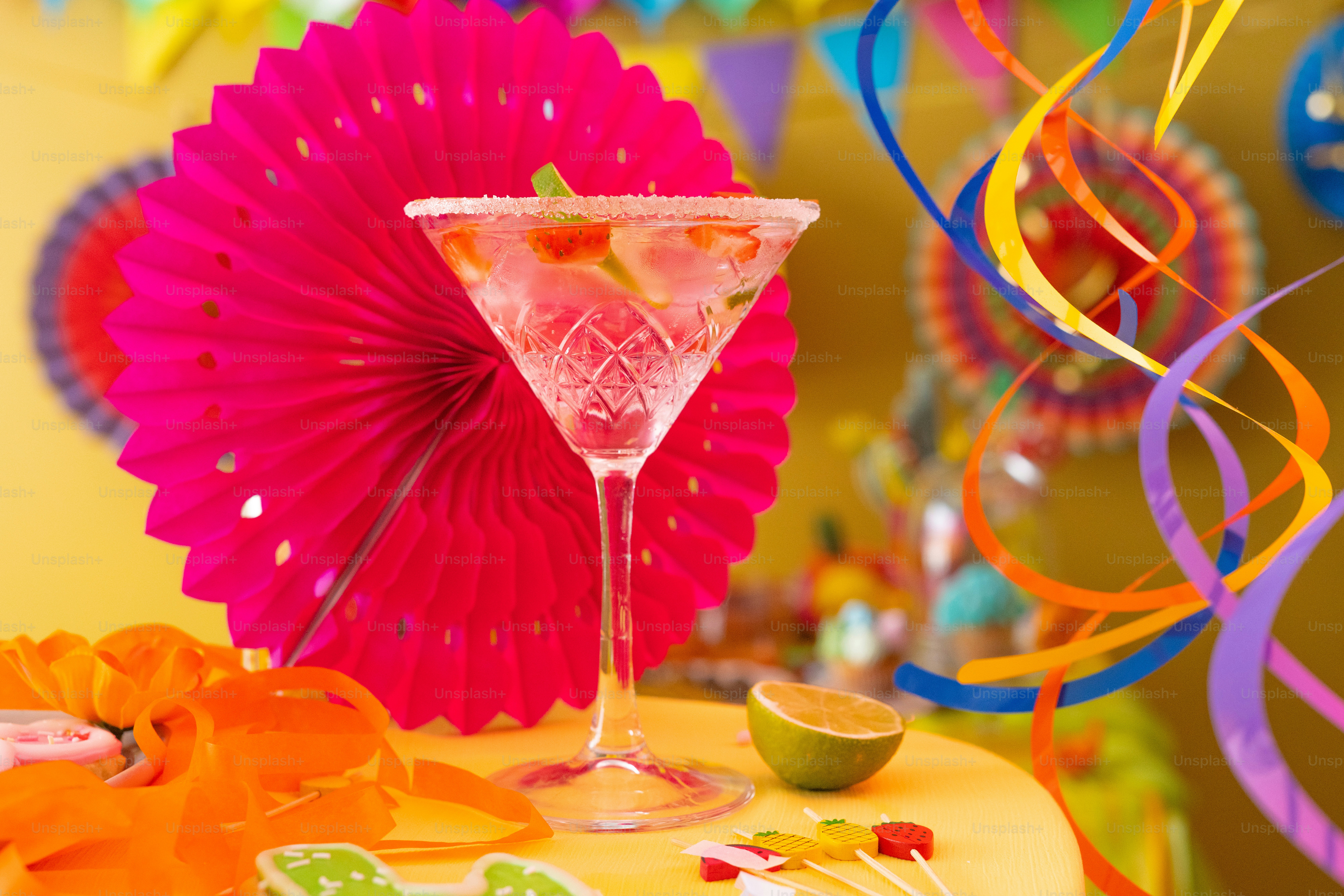 a pink cocktail sitting on top of a table