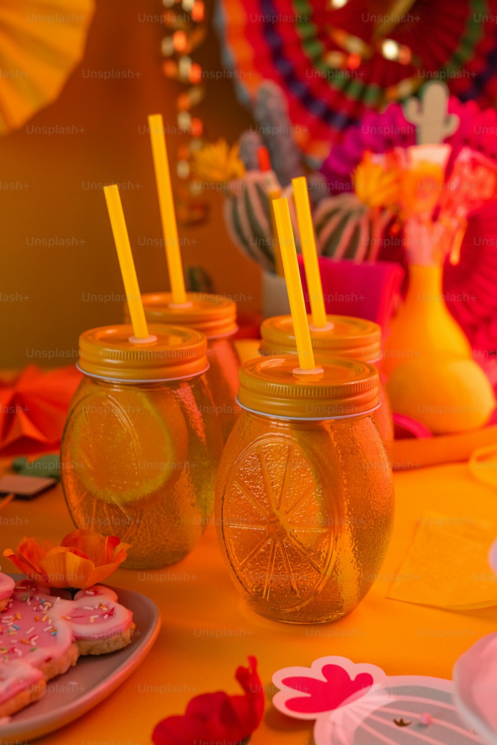 a table topped with mason jars filled with lemon slices