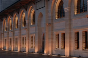 a large building with arched windows and a clock on the side of it