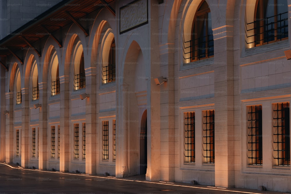 a large building with arched windows and a clock on the side of it