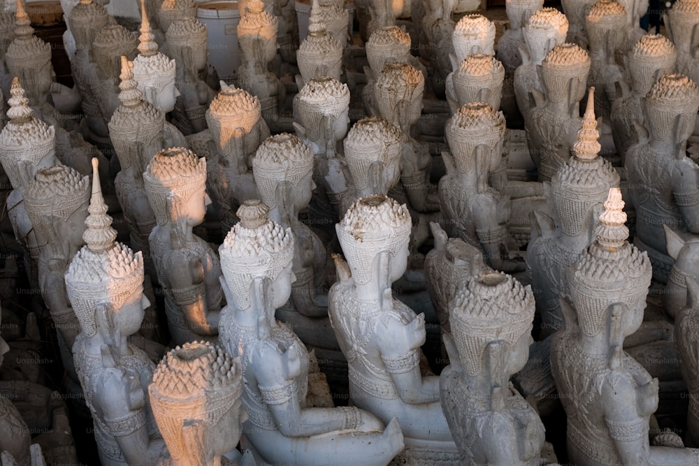 a large group of statues sitting next to each other