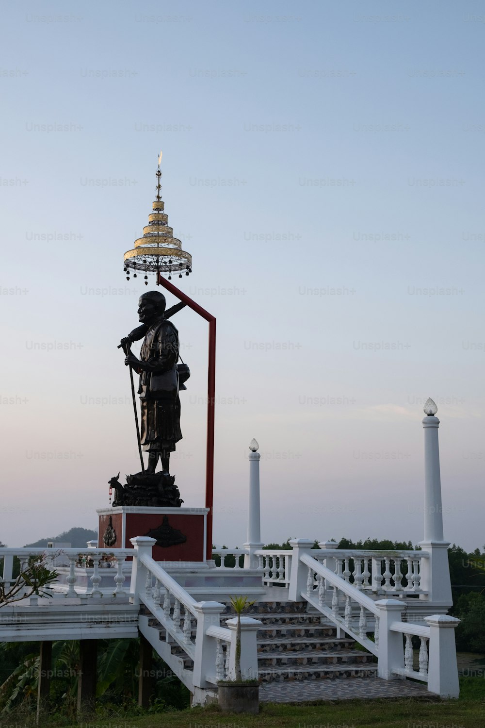 a statue of a man standing on a platform