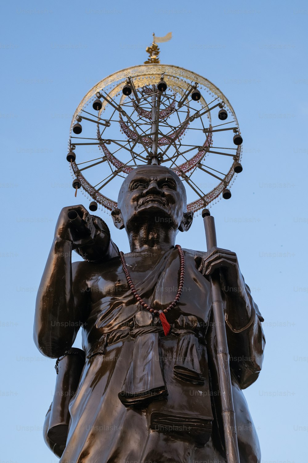 a statue with a ferris wheel on top of it