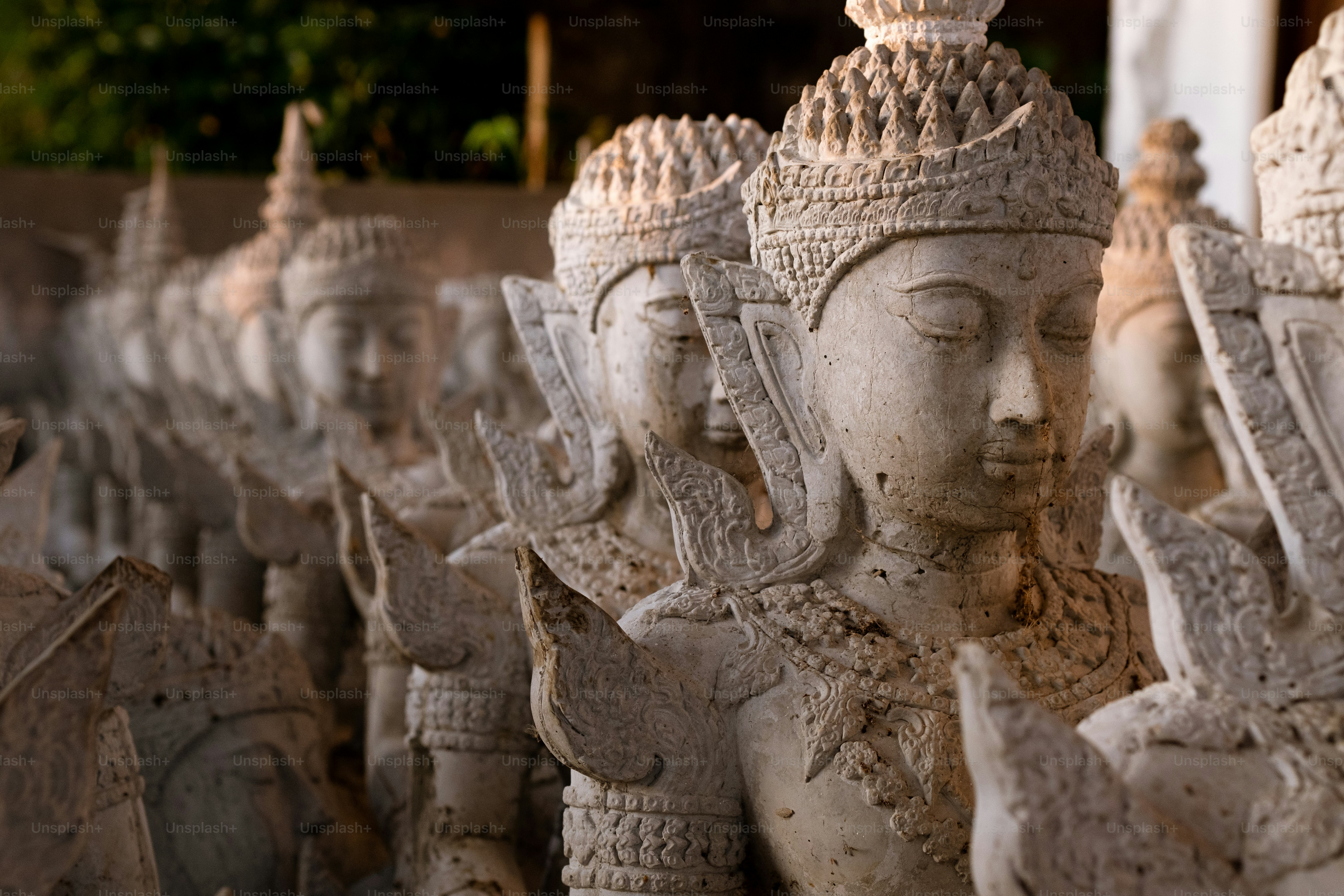 A group of statues of various sizes and shapes photo Buddha Image on