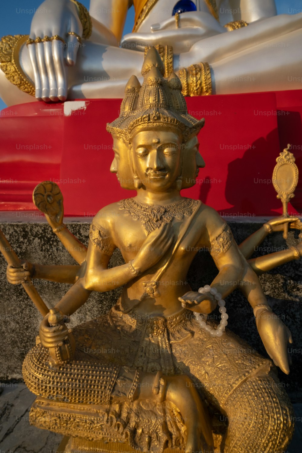 a golden statue sitting on top of a wooden table