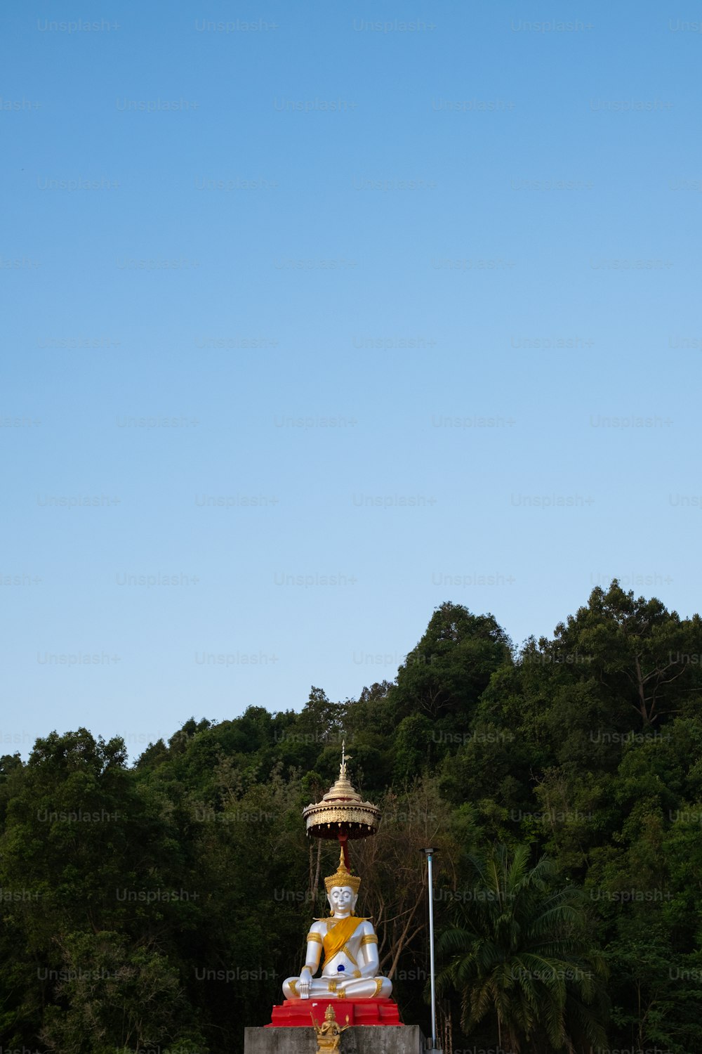 a statue of a person sitting on top of a bench