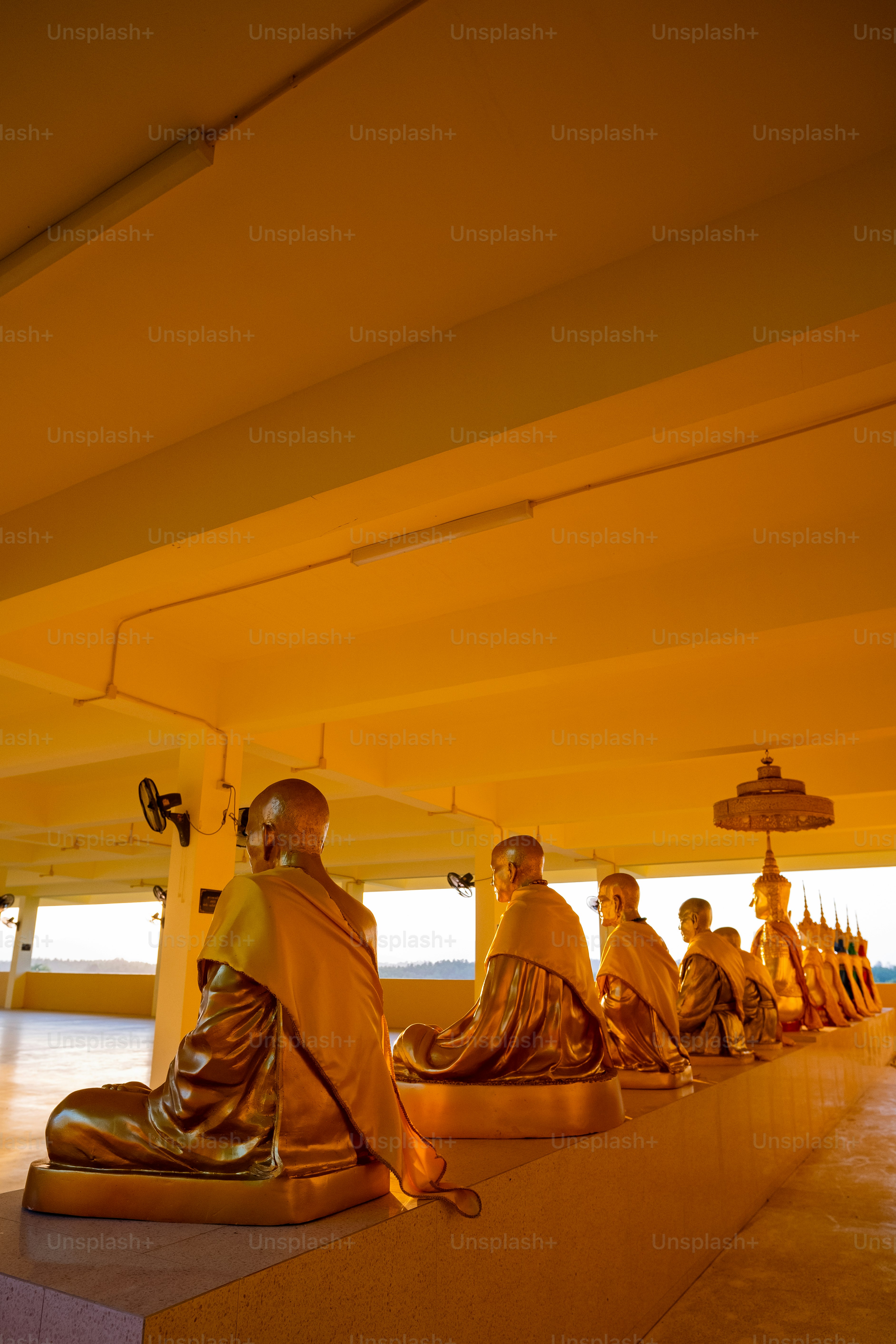 a group of people sitting on top of a cement platform