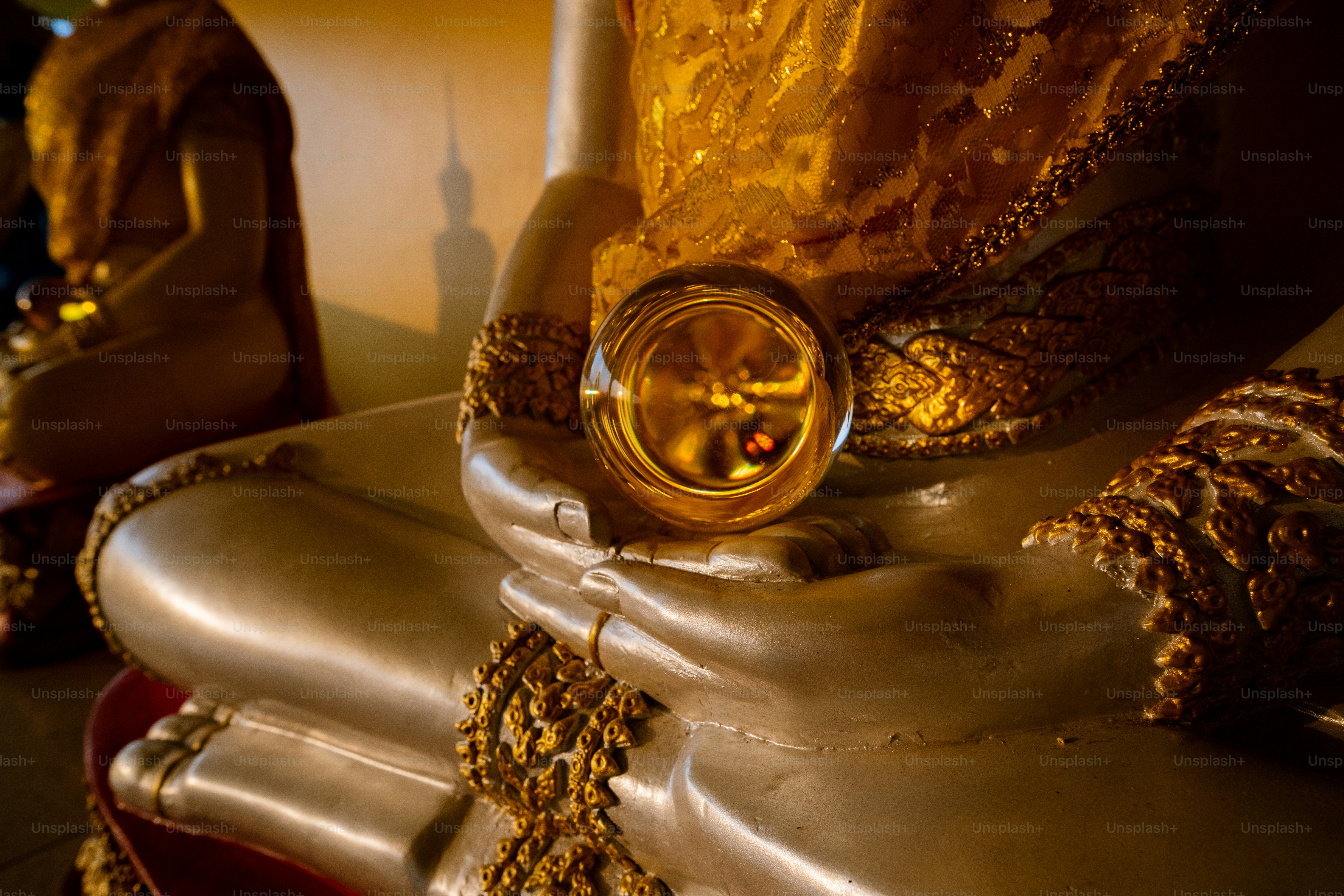 a statue of a buddha with a ring on it's finger