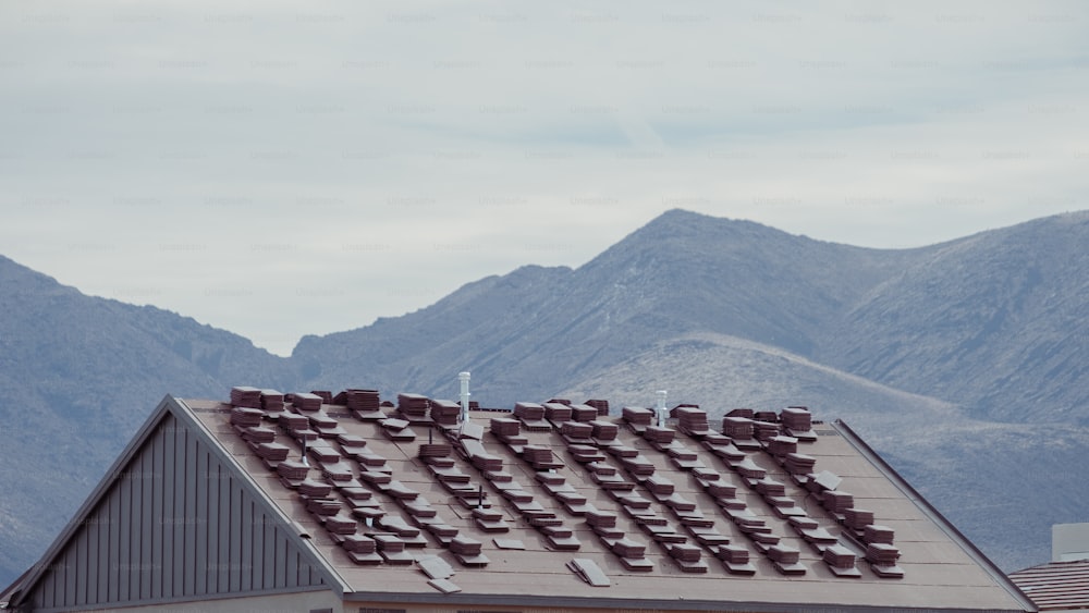 the roof of a house with mountains in the background
