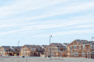 a row of houses under construction on a clear day