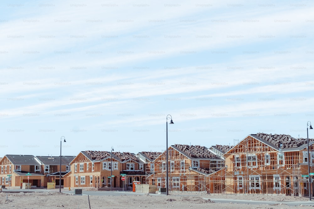 a row of houses under construction on a clear day