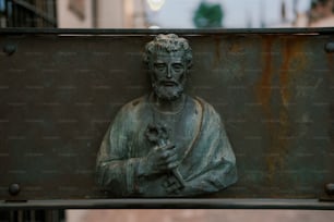 a statue of a man holding a flower