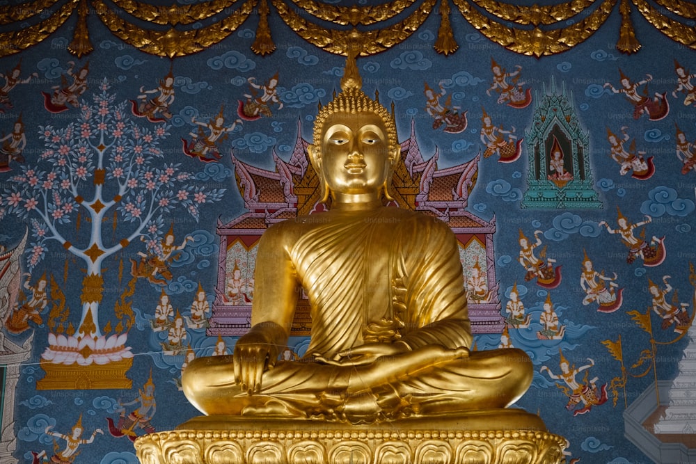 a golden buddha statue sitting on top of a table