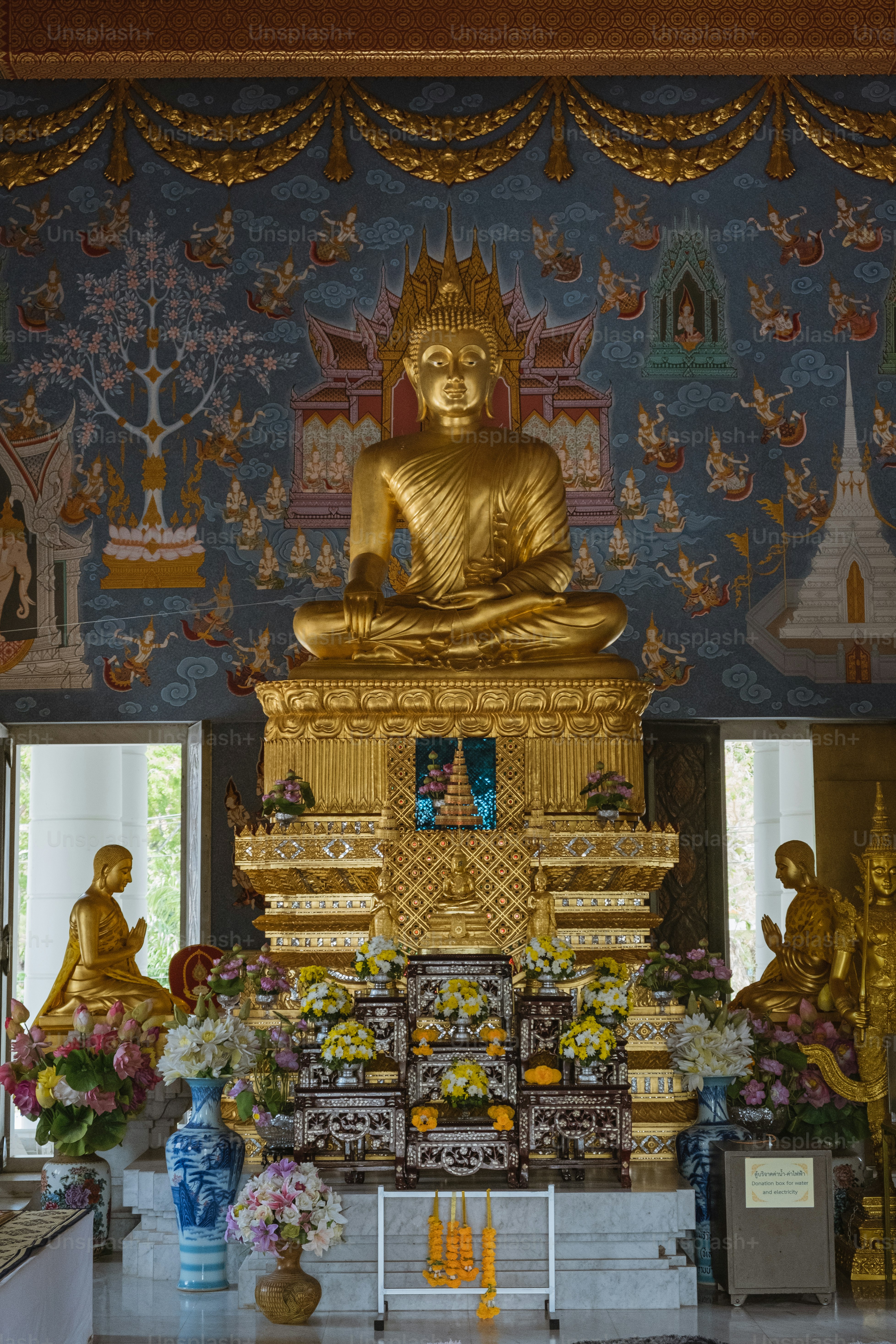 a large golden buddha statue sitting in a room