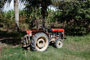 a red tractor is parked in a field