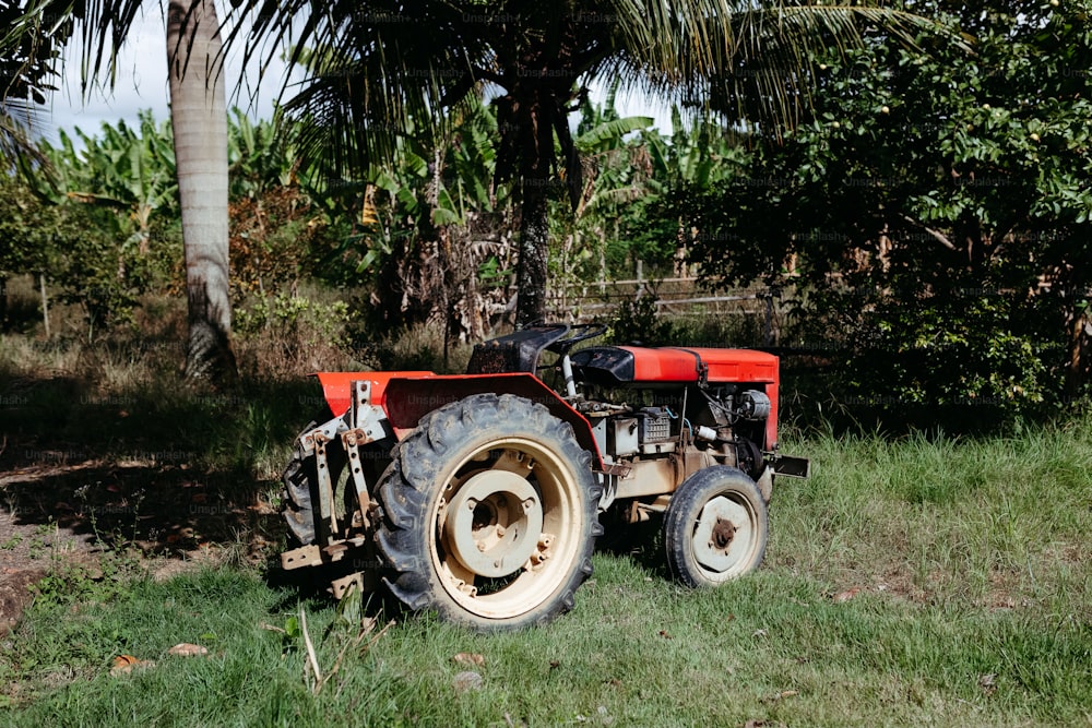 a red tractor is parked in a field