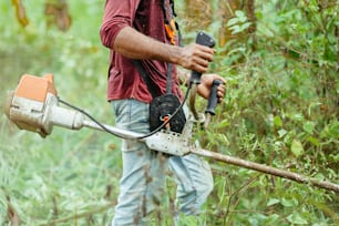 a man using a chainsaw to cut a tree