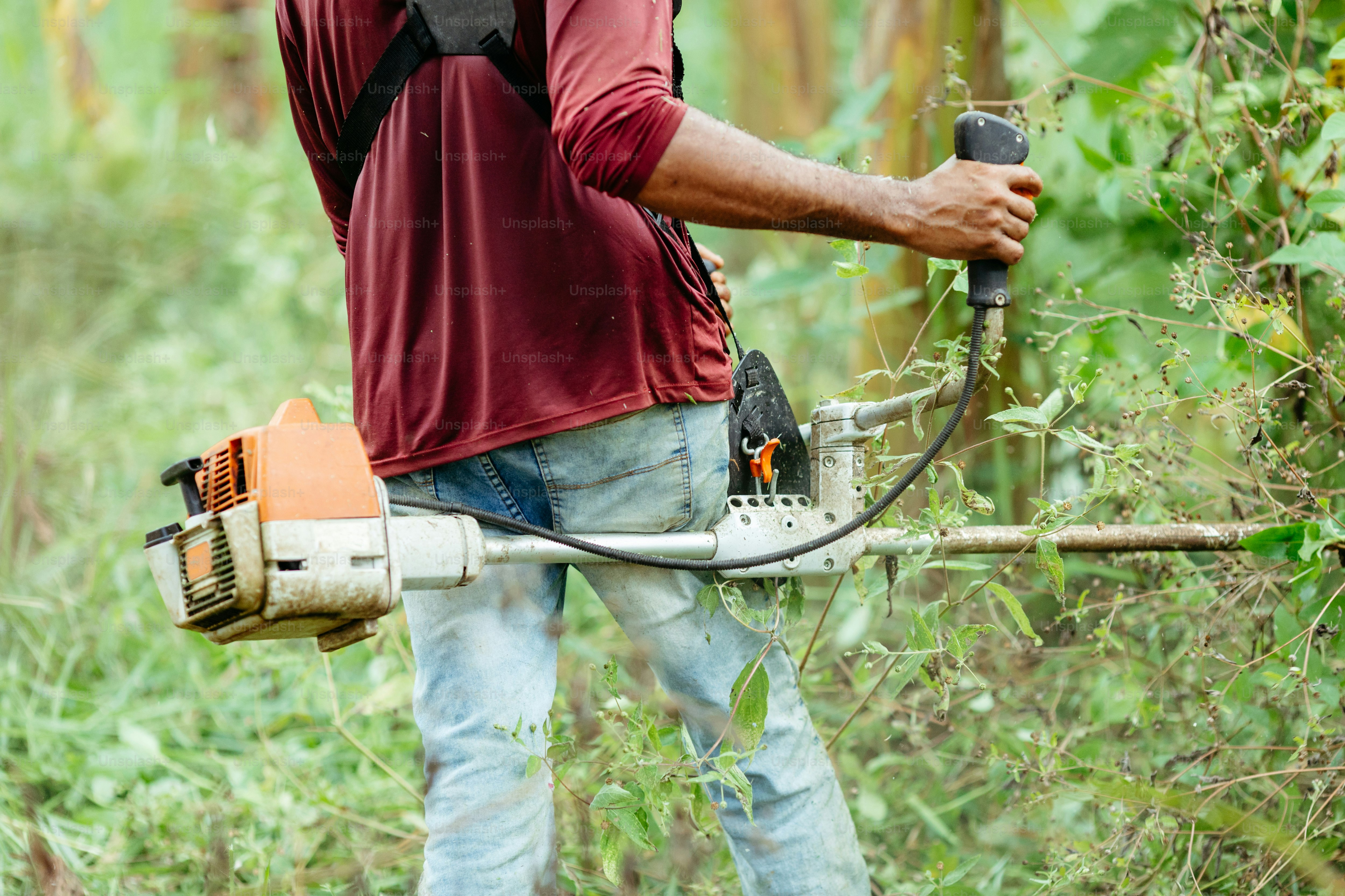 a man in a red shirt holding a power tool