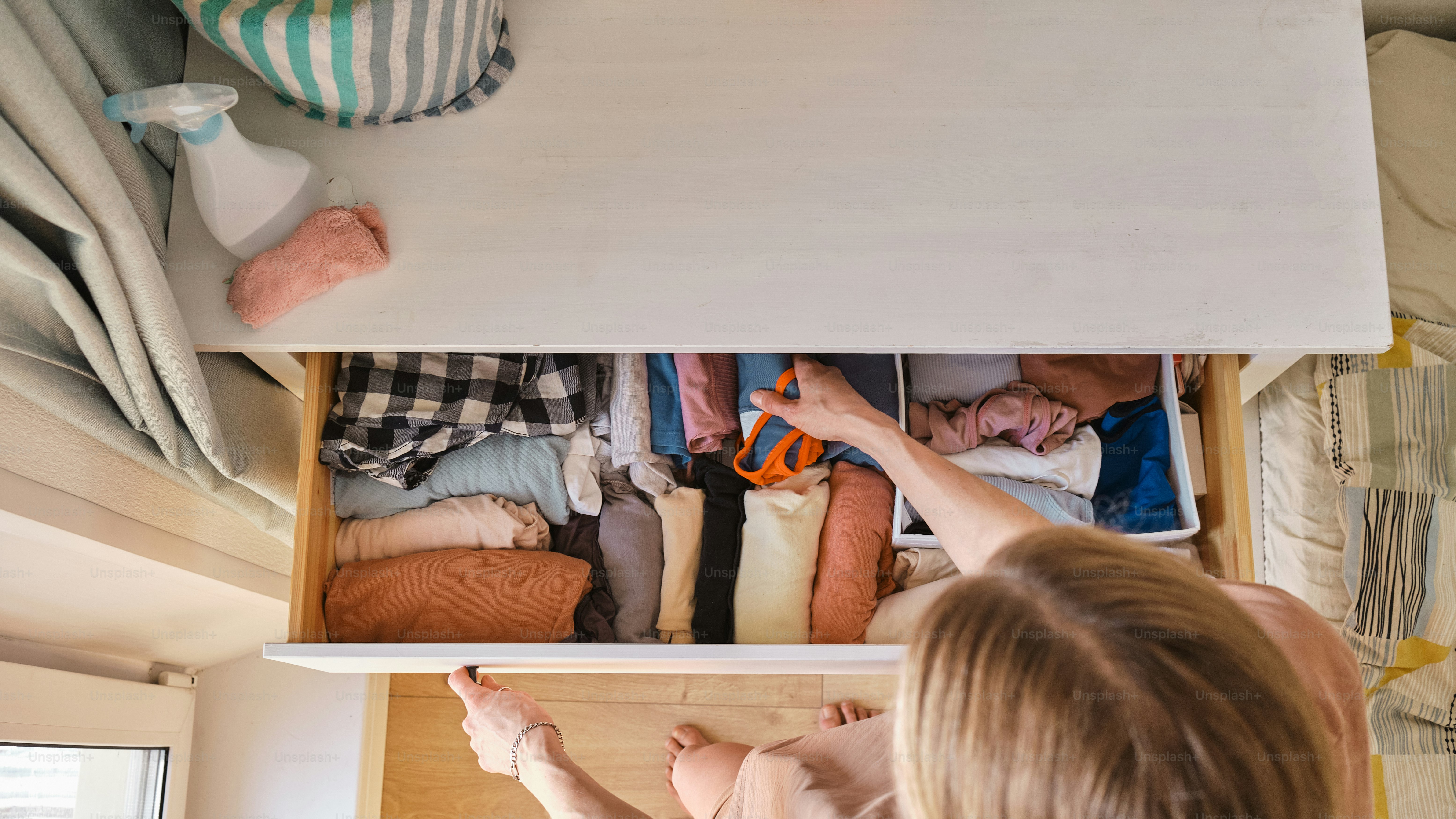 a woman is holding a baby in a drawer