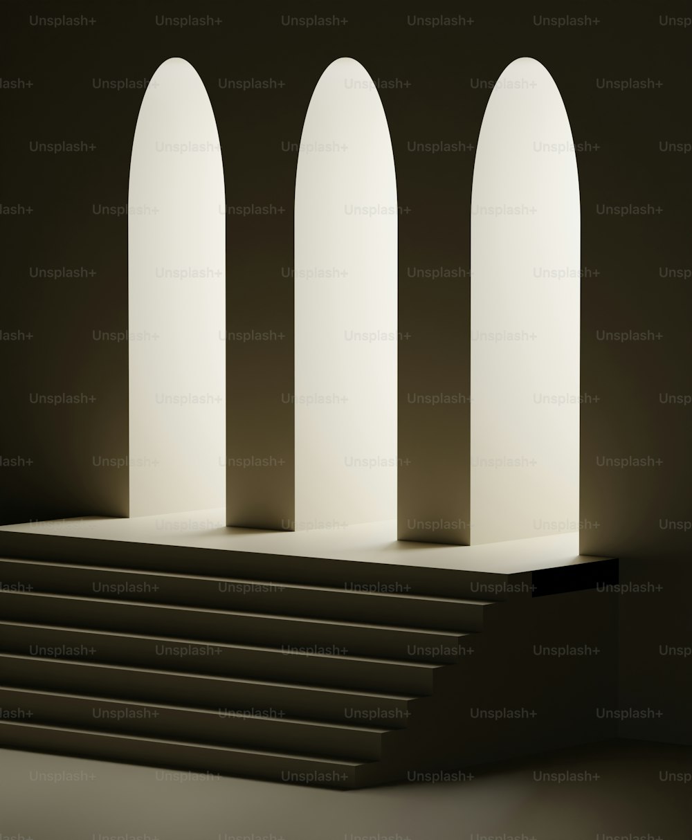 a group of white arches sitting on top of a set of steps