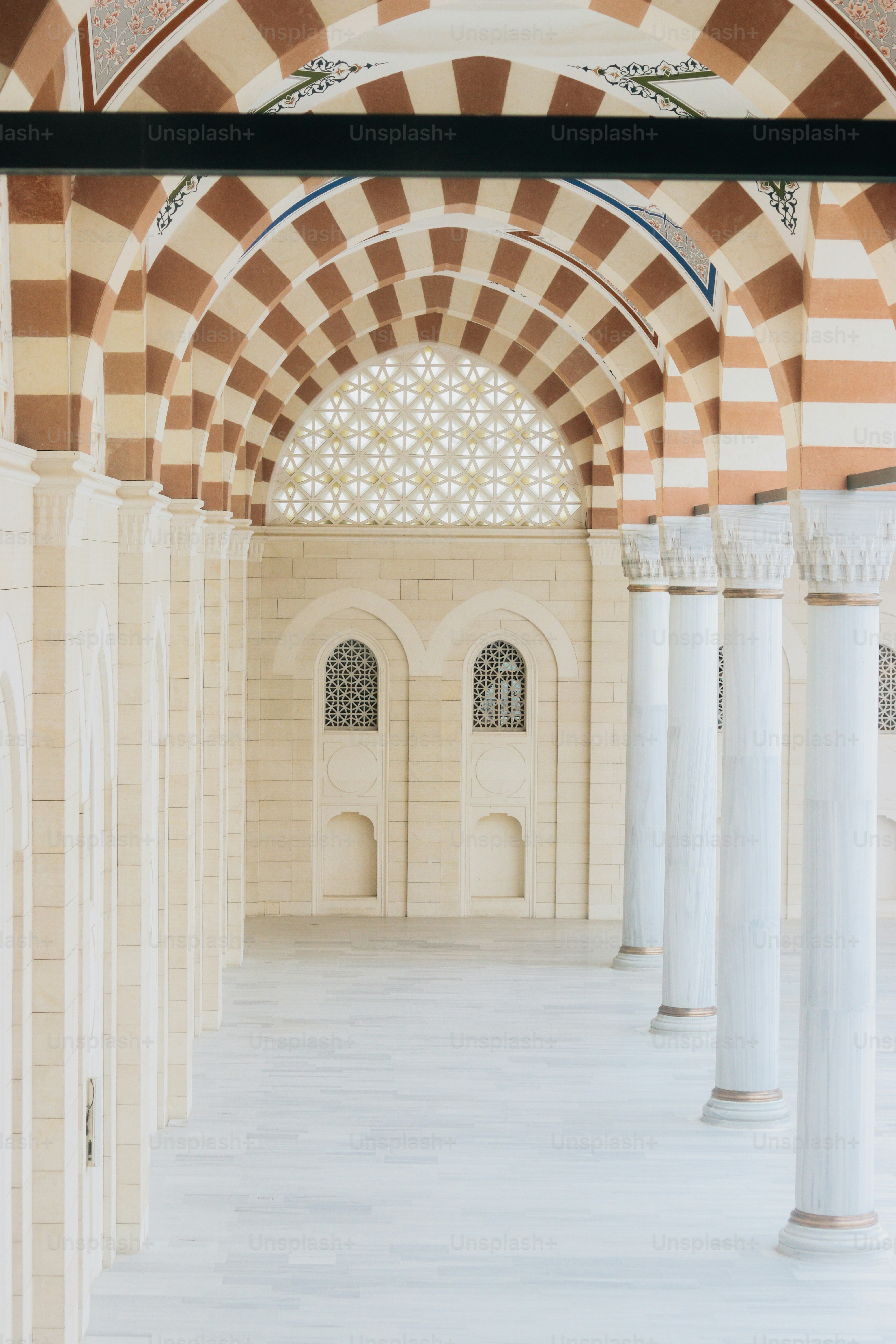 a large room with columns and a ceiling