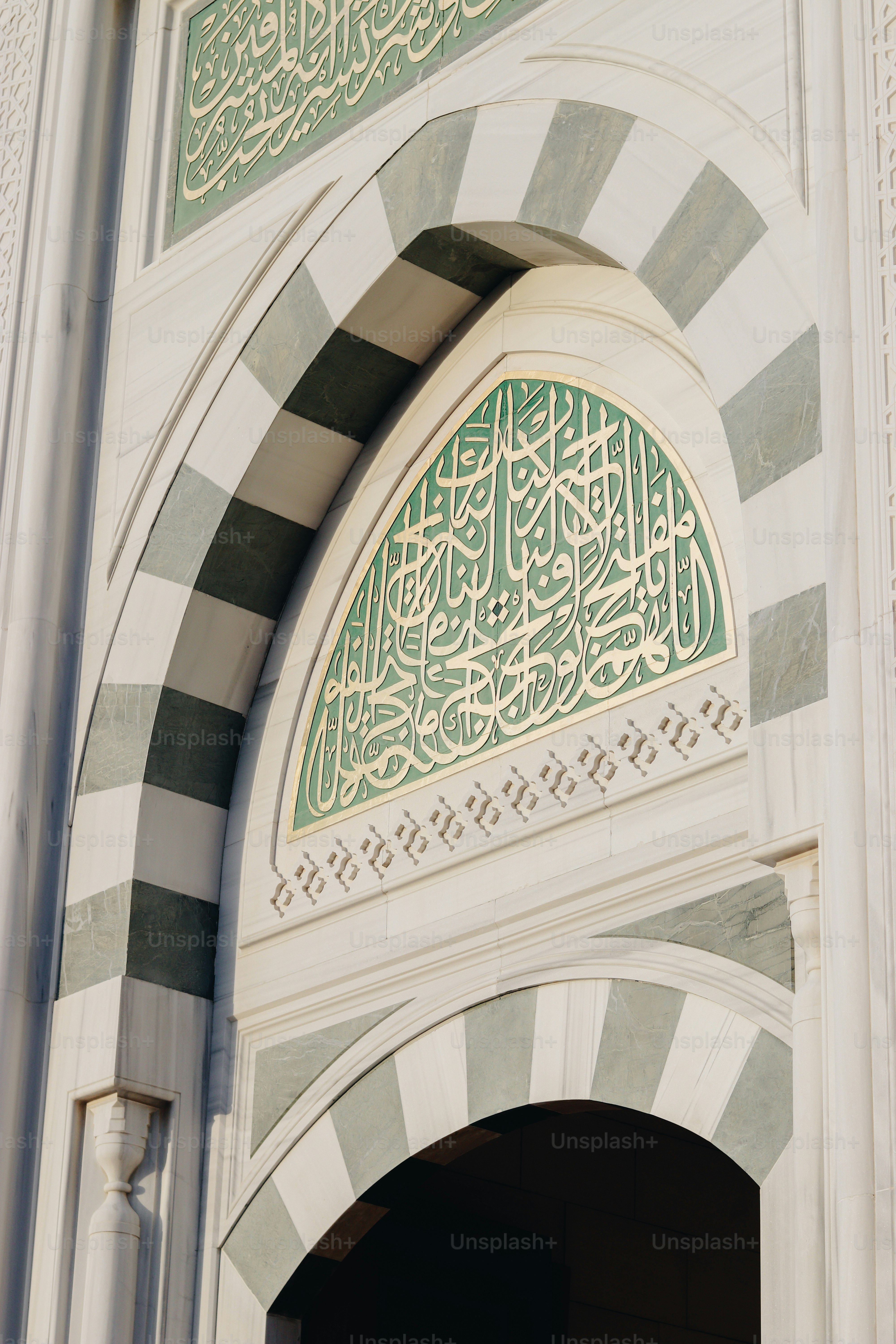 a white building with a green and white design on it