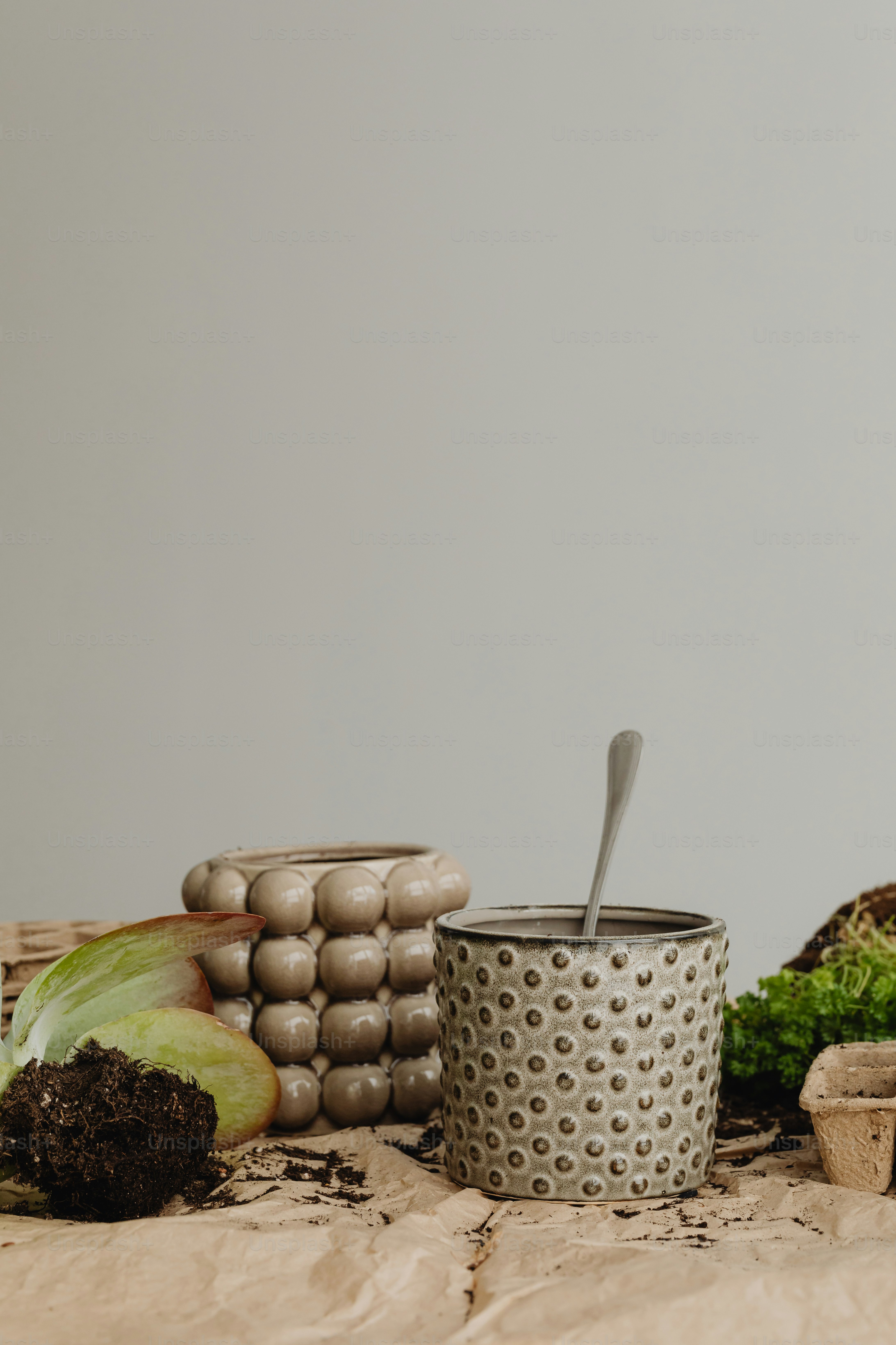 a table topped with a cup filled with food