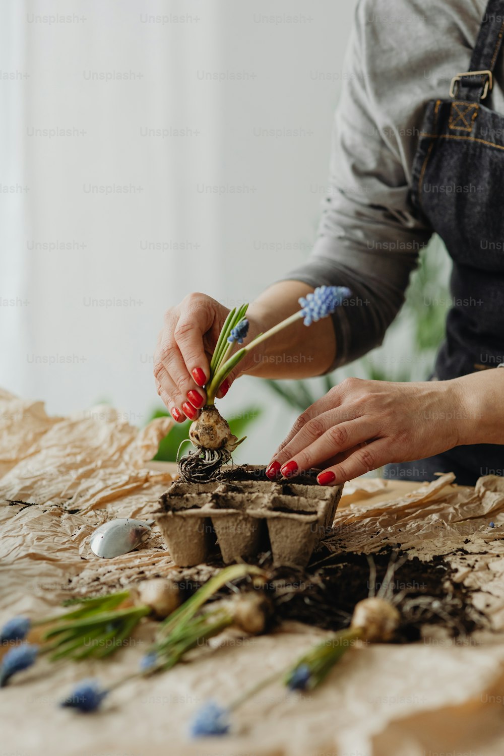 a woman arranging flowers in a flower pot