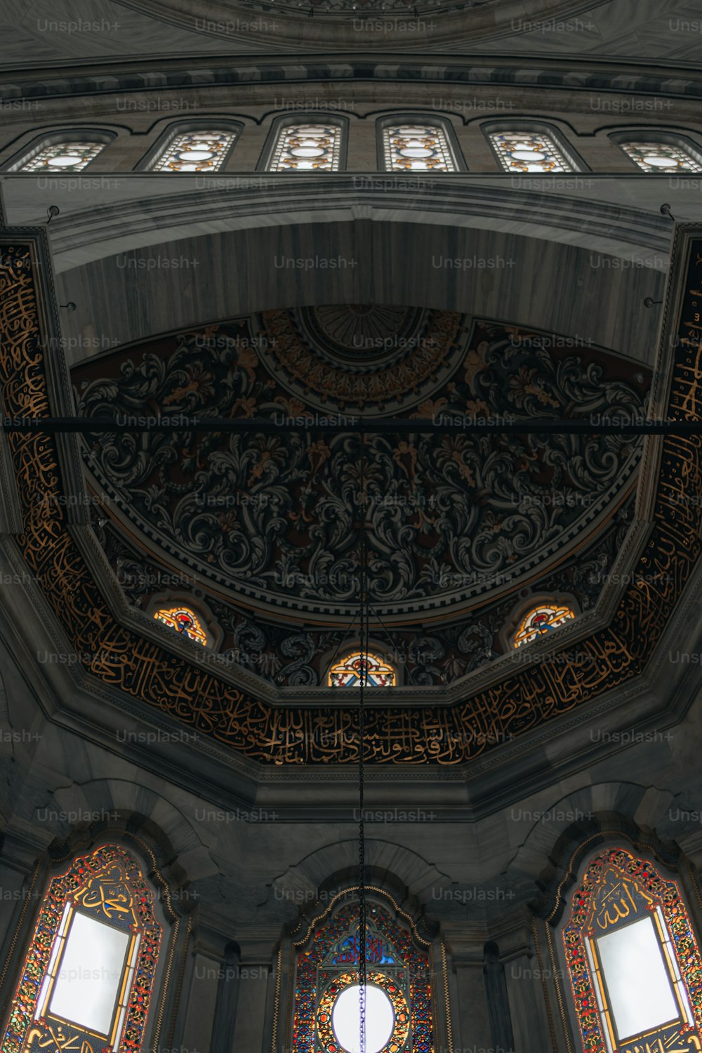 the ceiling of a church with stained glass windows