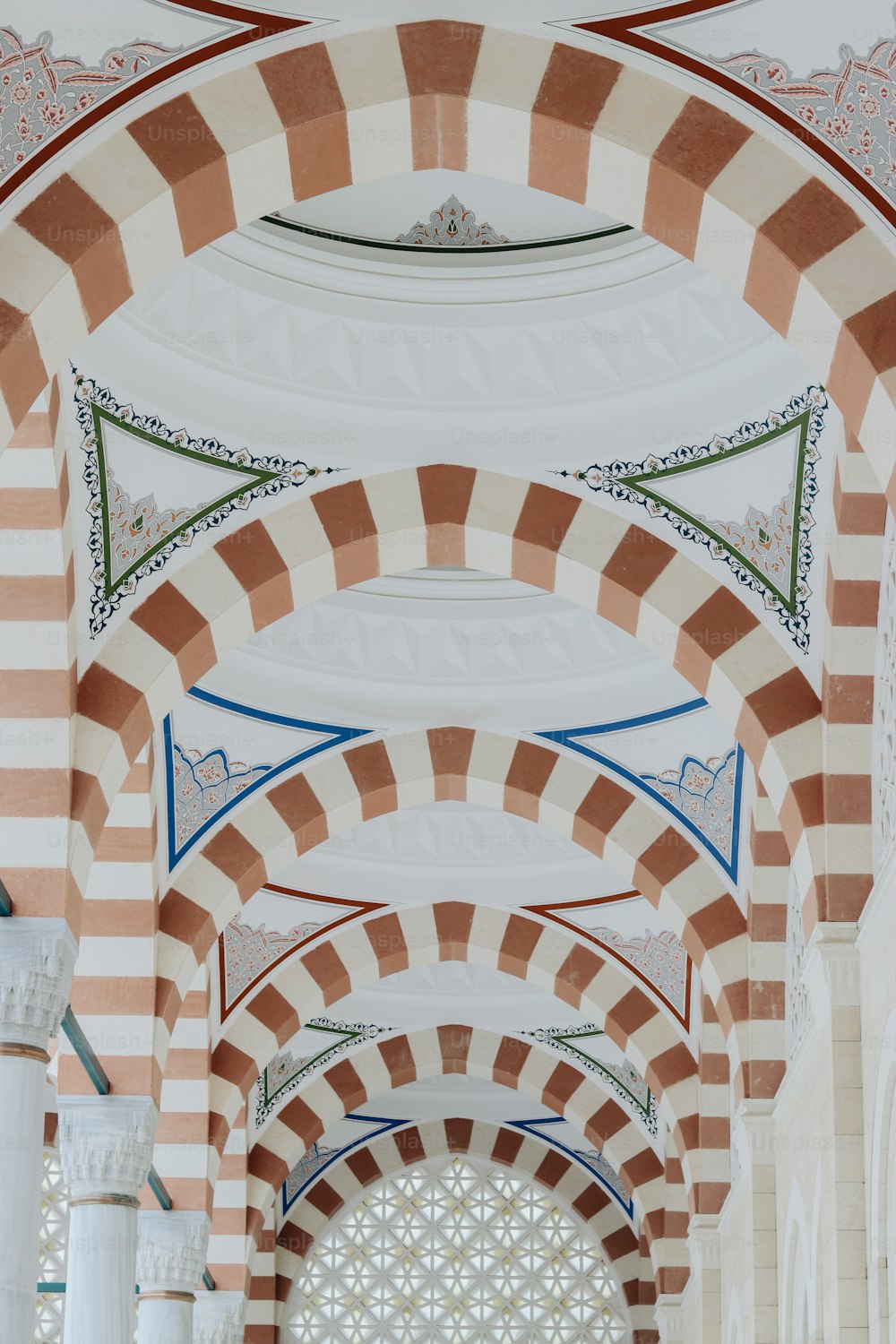 an archway in a building with a clock on the wall